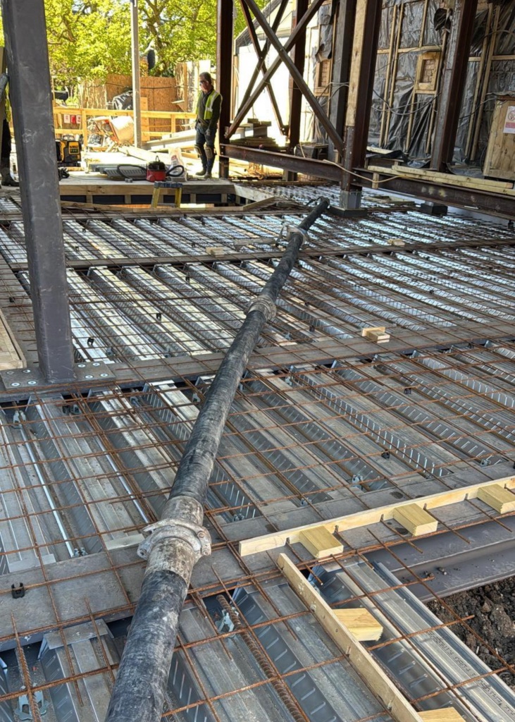 A King Concrete Pumping line pump feeding concrete on site near Horsham